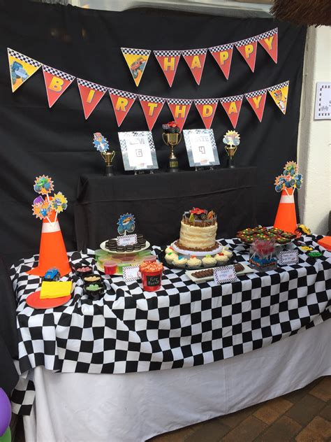 A Black And White Checkered Table Topped With Cake
