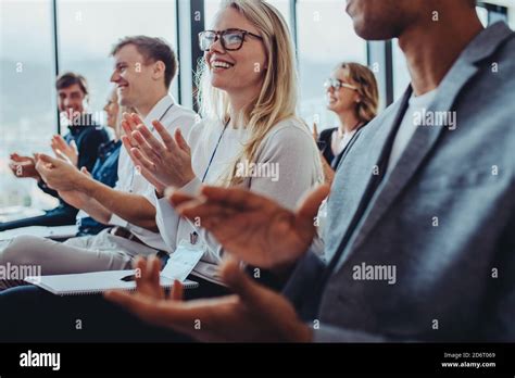 Team Of Businesspeople Clapping Hands While Having A Conference