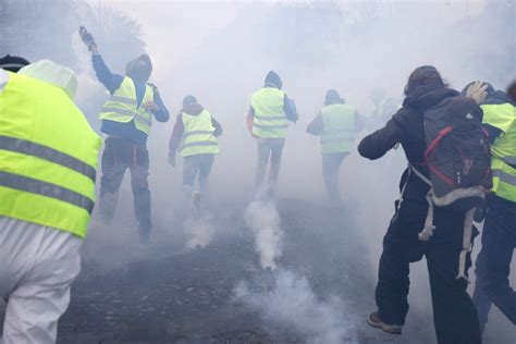 Paris Police Fire Tear Gas Water Cannon Against Yellow Vest