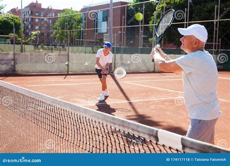Tennis Players Of Different Generations Playing Tennis Court Stock