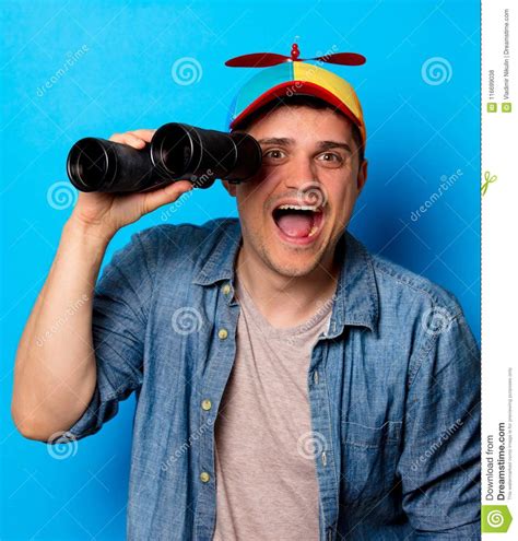Young Nerd Man With Noob Hat Using A Binoculars Stock Photo Image Of
