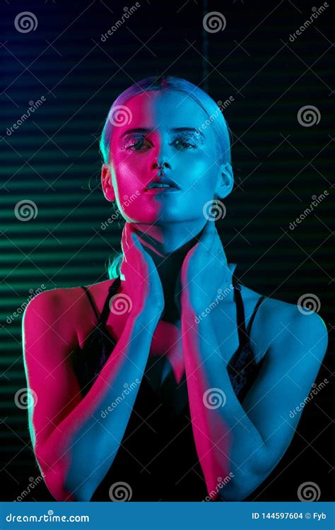 Fashion Model Blonde Woman In Colorful Bright Neon Lights Stock Photo