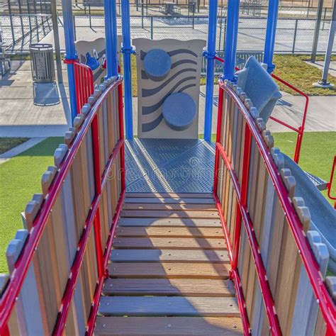 Clear Square Playground Equipment With A Bridge And Slide Against