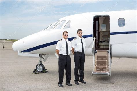 Pilots Standing In Front Of Private Jet — Stock Photo © Simplefoto