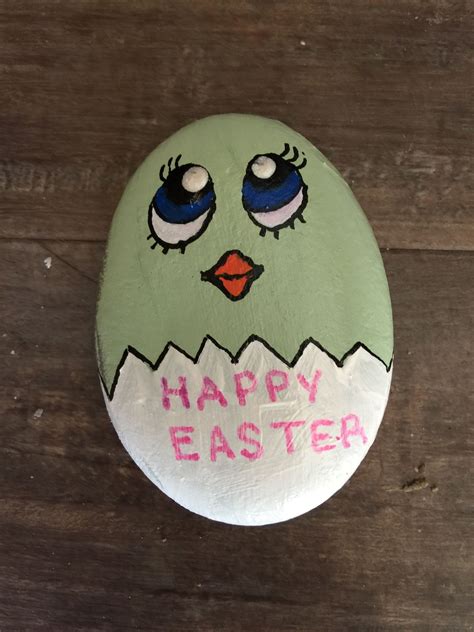 An Egg With Eyes And The Words Happy Easter Painted On It Sitting On A