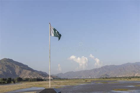 Pakistan Flag With A Beautiful Mountains And River Landscape Background