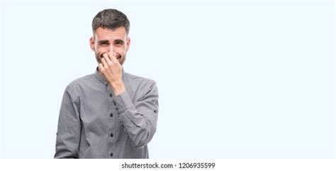 Young Hipster Man Smelling Something Stinky Stock Photo 1206935599