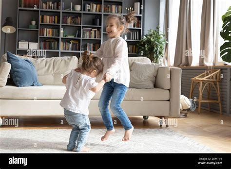 Excited Little Girls Kids Dancing In Living Room Stock Photo Alamy