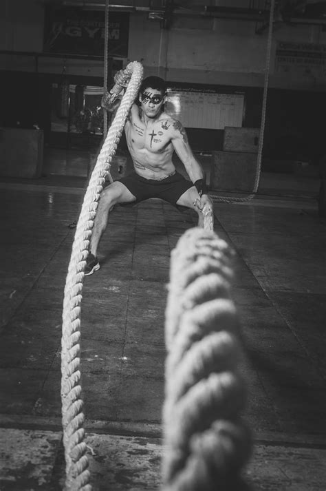 Grayscale Photography Of Man Holding Ropes · Free Stock Photo