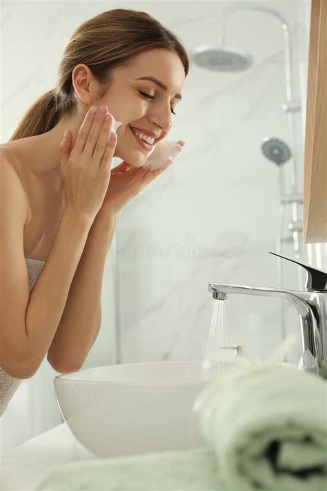 Young Woman Applying Cleansing Foam Onto Her Face In Bathroom Stock Image Image Of Face