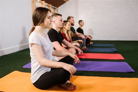 Premium Photo A Group Of A Young People Doing Joga Exercises Indoors