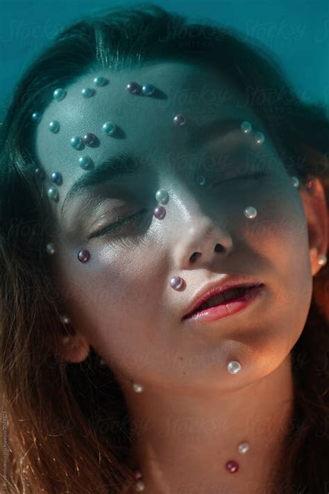 Beauty Portrait Of Young Attractive Woman With Pearls On Her Face By Stocksy Contributor