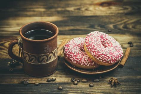 Delicious Donuts With Chocolate And A Cup Of Coffee In Warm Colors