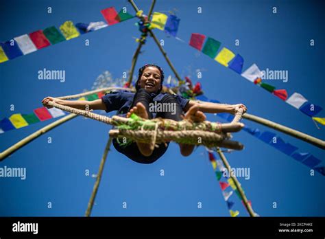A Nepalese Kid Rides A Traditional Swing Set Up As Part Dashain