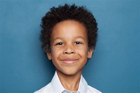 Happy African American Child Boy Smiling On Blue Background Close Up