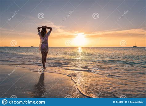 Beautiful Young Woman On The Sandy Beach At Sunset Stock