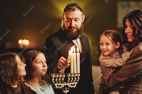Premium Photo Portrait Of Orthodox Jewish Man Lighting Menorah Candle
