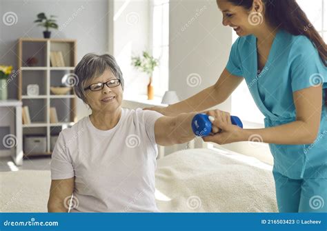 Elderly Woman Patient Rehabilitation With Professional Nurse Help At