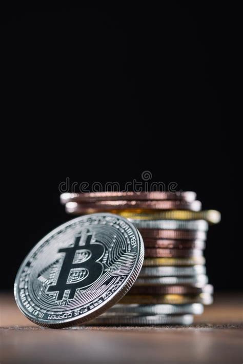 Close Up View Of Bitcoin Leaning On Stack Of Various Bitcoins Stock
