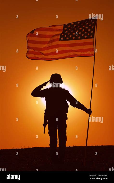 Usa Soldier With Flag Saluting On Sunset Horizon Stock Photo Alamy