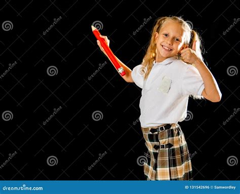 Adorable Blonde Haired Schoolgirl With Two Ponytail And Uniform Writing