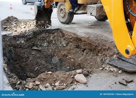 Digging A Deep Trench And Filling It With Stone Gravel To Construct A