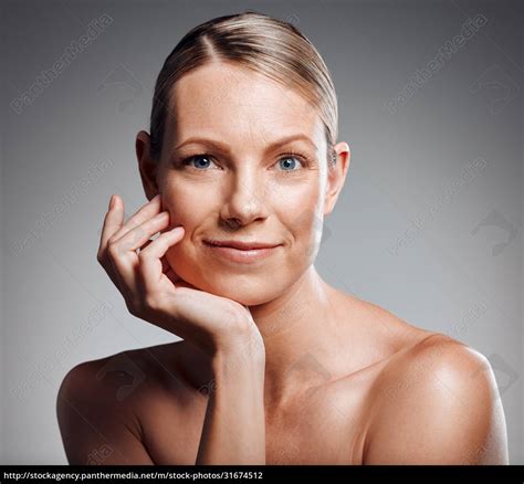 Beautiful Mature Woman Posing In Studio Against A Grey Royalty Free