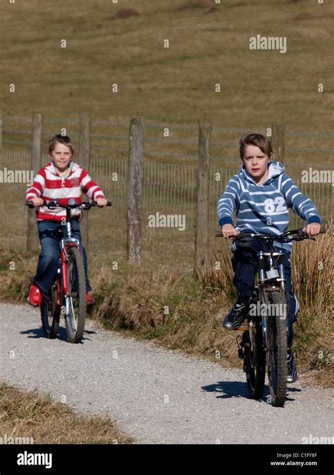 Two Young Boys Riding Bicycles Uk Stock Photo Alamy