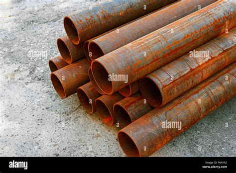 Iron Pipes Covered With Rust In Stack Stock Photo Alamy