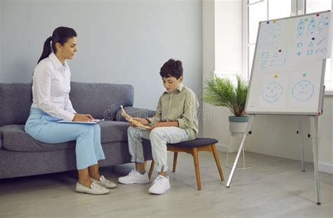 Psychologist School Counselor Or Teacher Communicating With Little