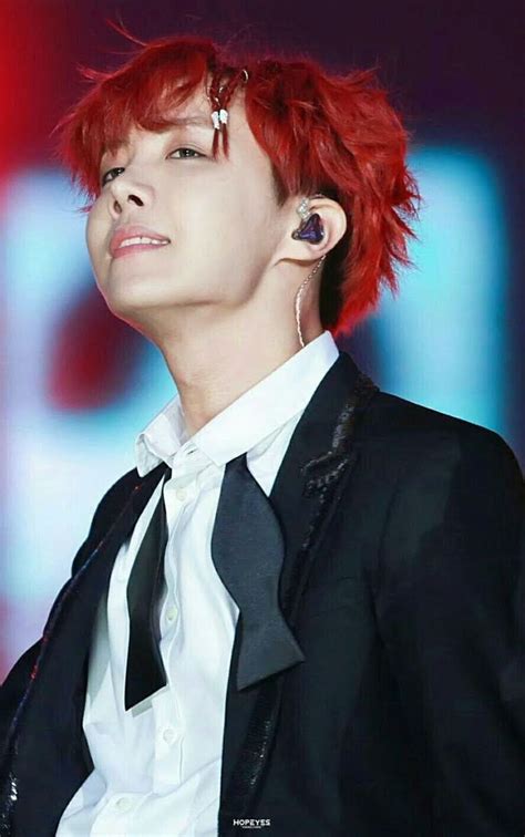 A Man With Red Hair Wearing A Black Suit And White Shirt Is Looking Up