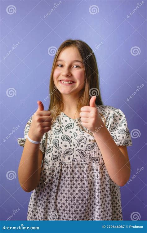 Cheerful Little Girl Showing Two Fingers Up In Approving Gesture Stock