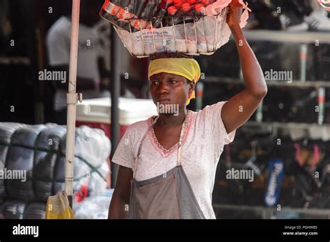 kumasi ghana jan 16 2017 unidentified ghanaian woman carries a basket on her head people