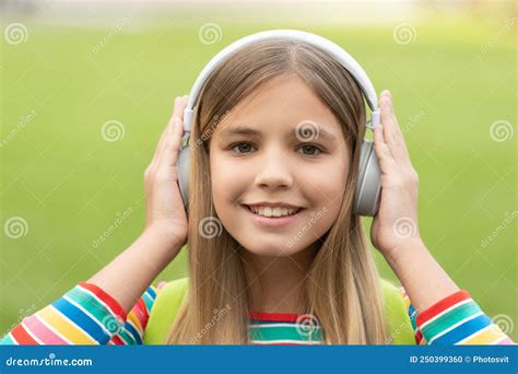 Portrait Of Happy Girl With Smiling Face Listening To Music In