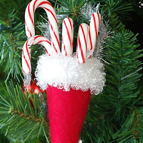 Make these large peppermint candy decorations for your christmas garland by using paper plates and paint. Have a candylicious Christmas with these creative candy cane decorations | Ideal Home