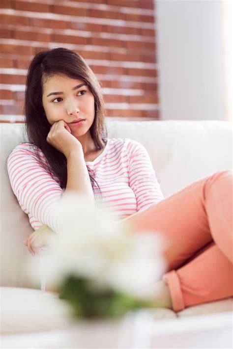 Upset Asian Woman On Couch Stock Photo Image Of Depressed