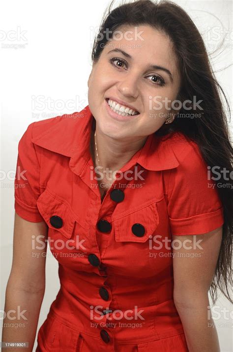 Beautiful Young Woman In Red Dress Smiling At Camera Stock Photo