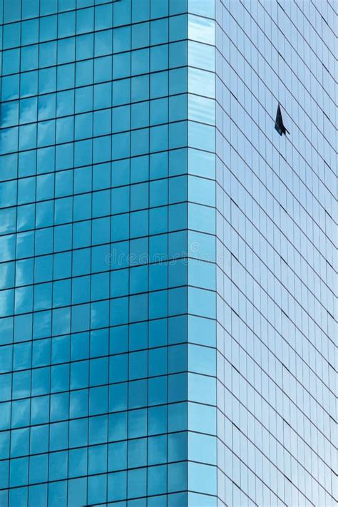 High Rise Glass Building With Sky And Clouds Reflection Stock Photo