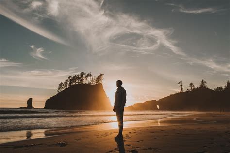 Silhouette Of Man Standing On Beach During Sunset · Free Stock Photo
