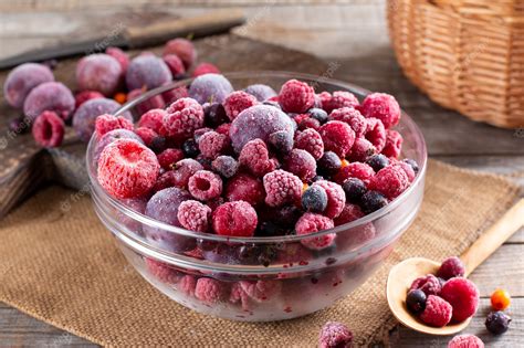 Premium Photo Assortment Of Frozen Berries In A Glass Bowl On Wooden