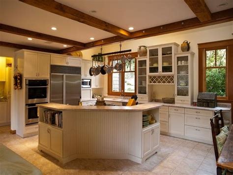 Open layout kitchen with white cabinets gray island cambria quartz ellesmere countertop black pendants and dark wood flooring kylie m interiors. stained windows with white trim | white kitchen with wood ...