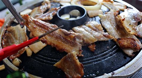 With a table full of banchans. Korean cooking kitchenware: Korean bbq grill plate ...