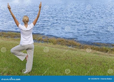 Young Woman Practicing Yoga By Tranquil Blue Lake Stock Photo Image