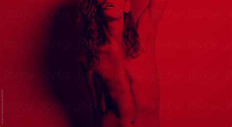 Unrecognisable Naked Transgender Woman Portrait Under Red Lights By Stocksy Contributor