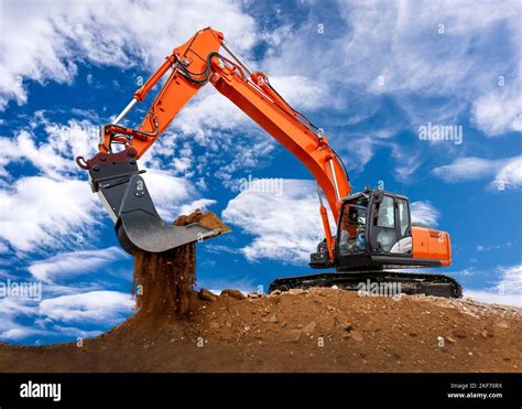 Excavator Is Digging And Loading At Construction Site Stock Photo Alamy