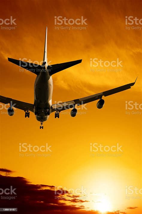 Xl Jet Airplane Landing At Sunset Stock Photo Download Image Now