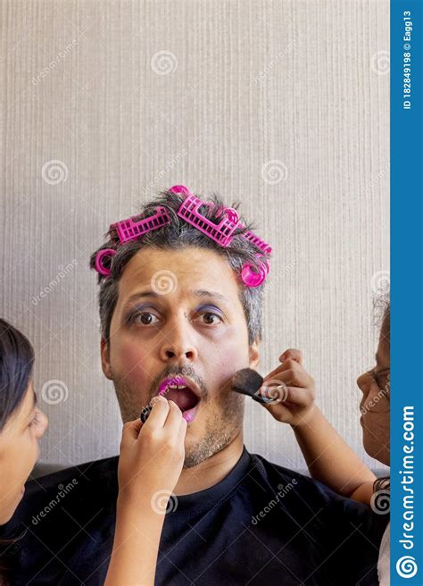 Handsome Father Is Being Makeup By The Hands Of His Daughters Stock