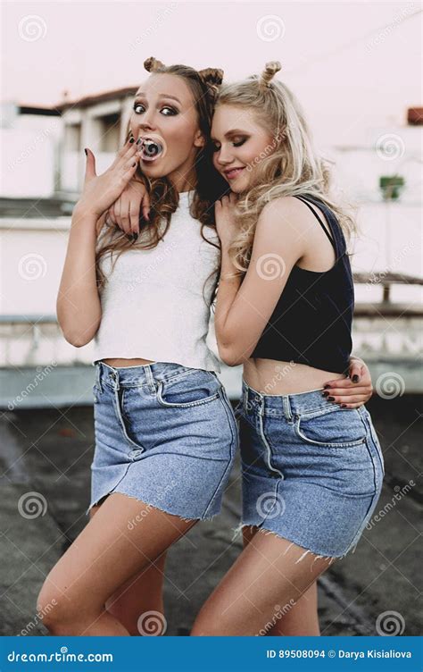 Lifestyle And People Concept Fashion Portrait Of Two Stylish Girls Best Friends Wearing Jeans