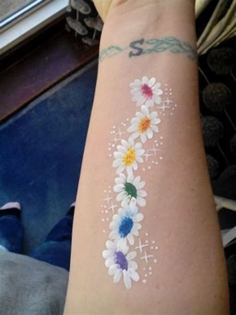 An arm tattoo of a cyclist sweating it out on the road, under the sun. Best 30 Chain Daisy Tattoo Design Ideas