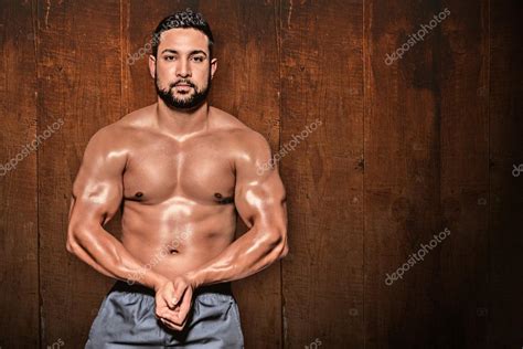 Portrait Of A Bodybuilder Man Flexing Muscles Stock Photo By